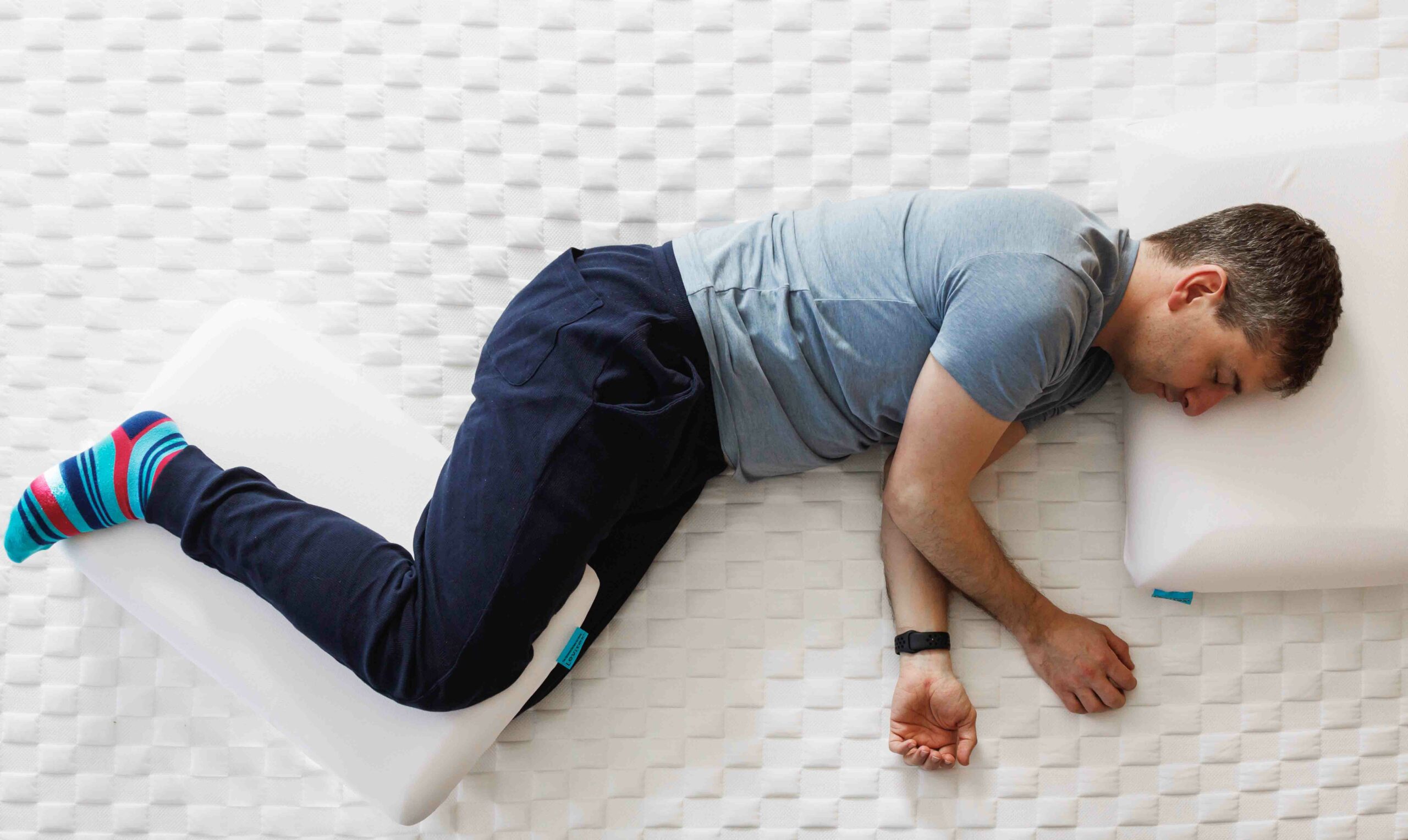 man on bed lying on his side