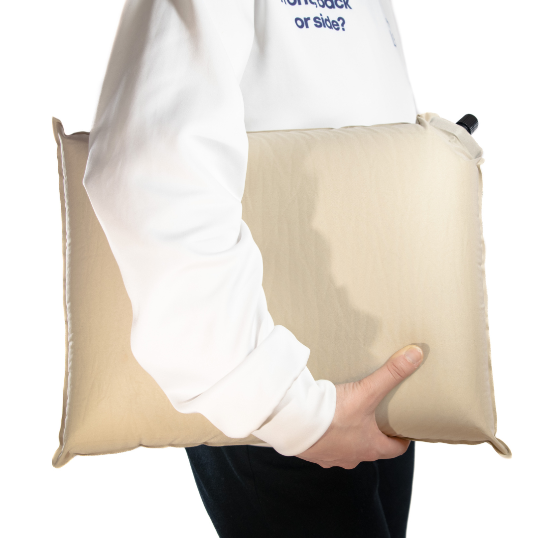 A 5'2 woman holding an Anywhere pillow